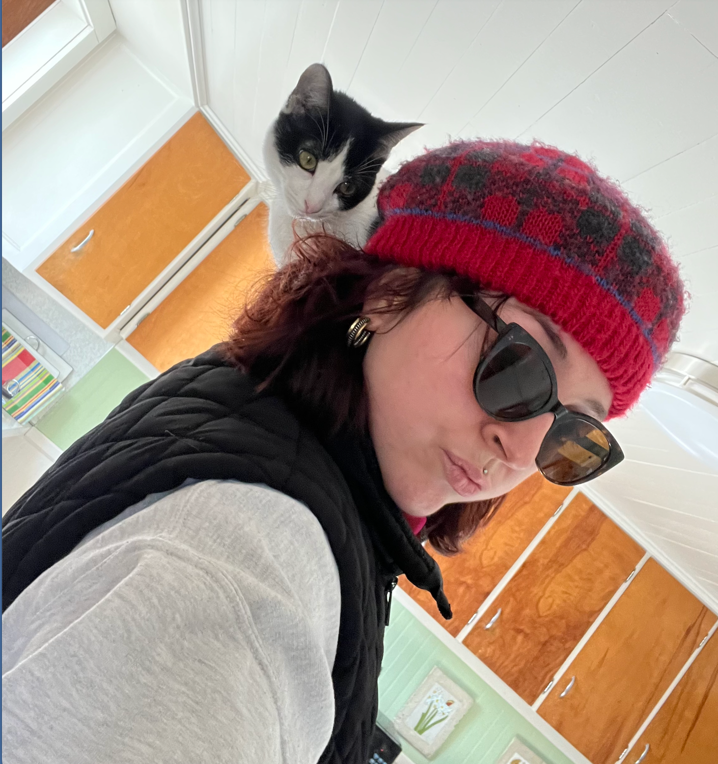 Julia Furlong with a cat perched affectionately on her shoulder
