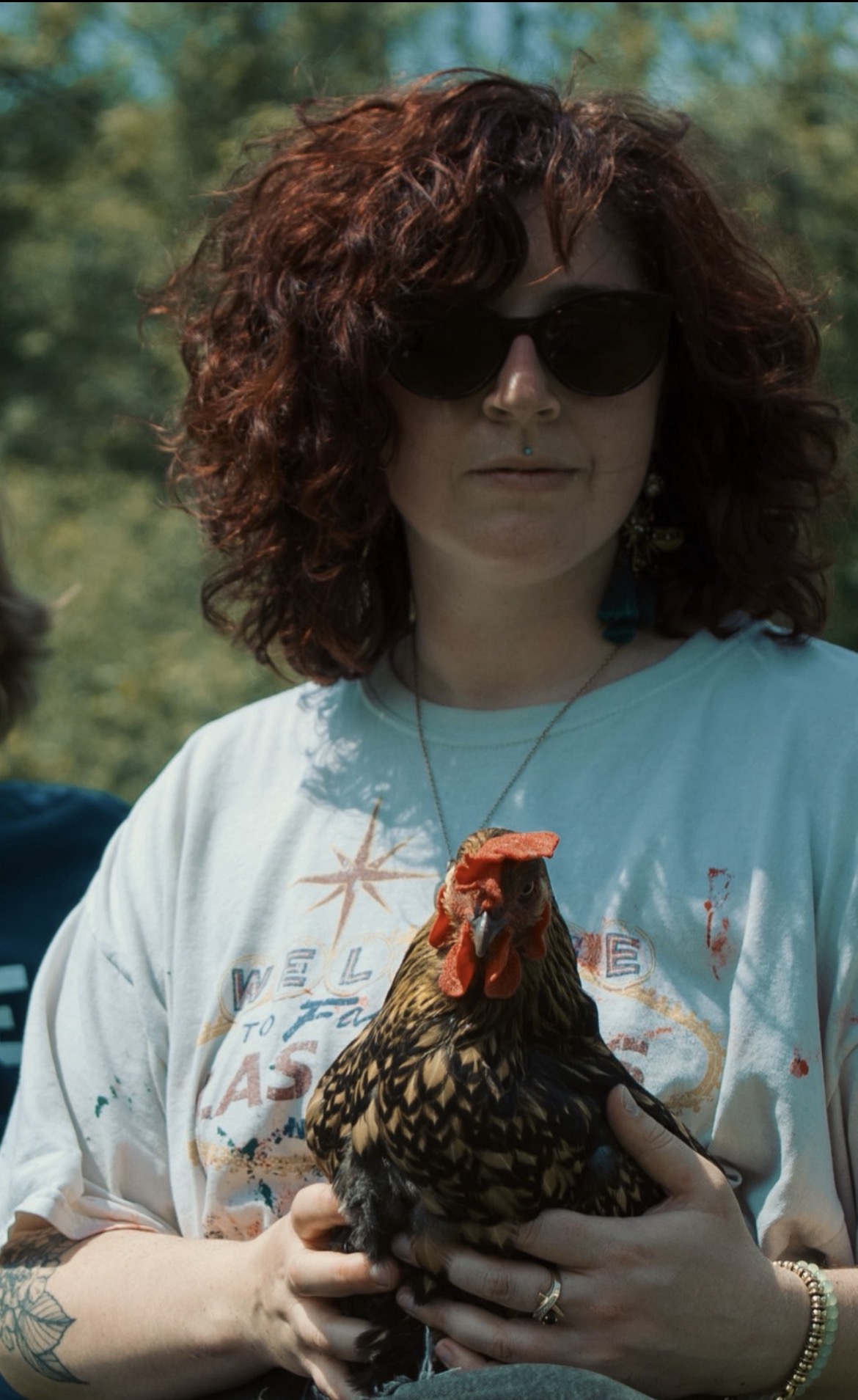 Julia Furlong holding a chicken outdoors